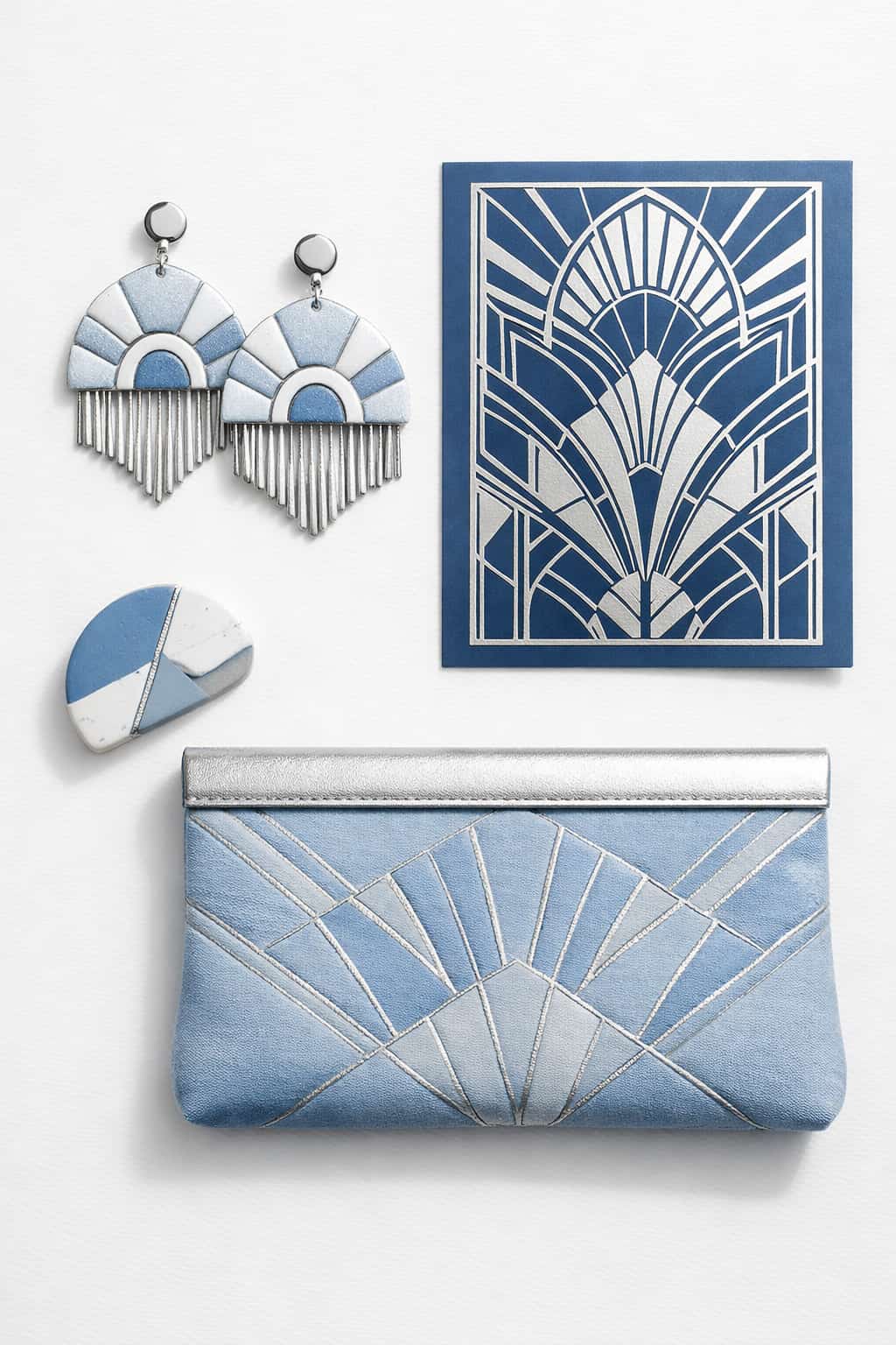 2026 modern glam trend mood board with handmade Art Deco fan earrings, foiled geometric card, stitched clutch, and two-tone polymer clay accent in cool blue.