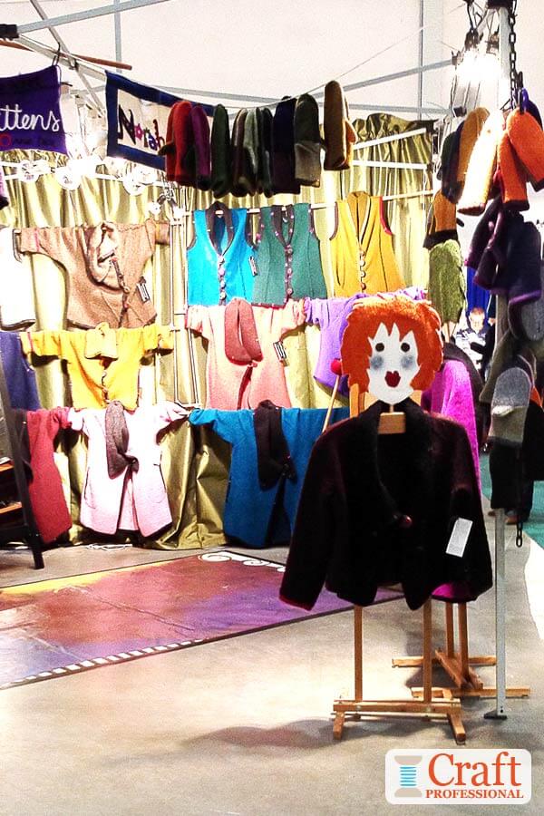 Handmade clothing displayed on a mannequin at a craft fair.