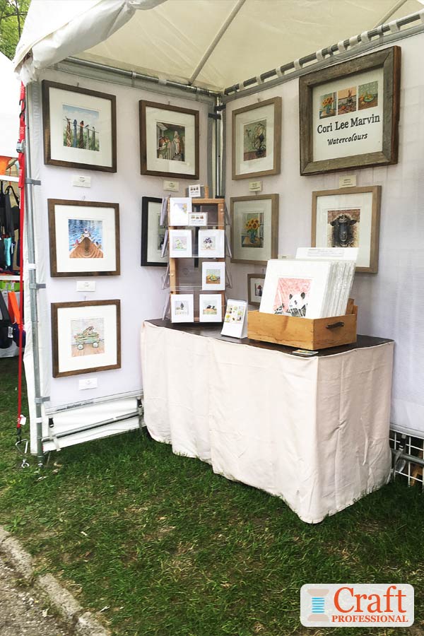 Framed art displayed at a craft fair