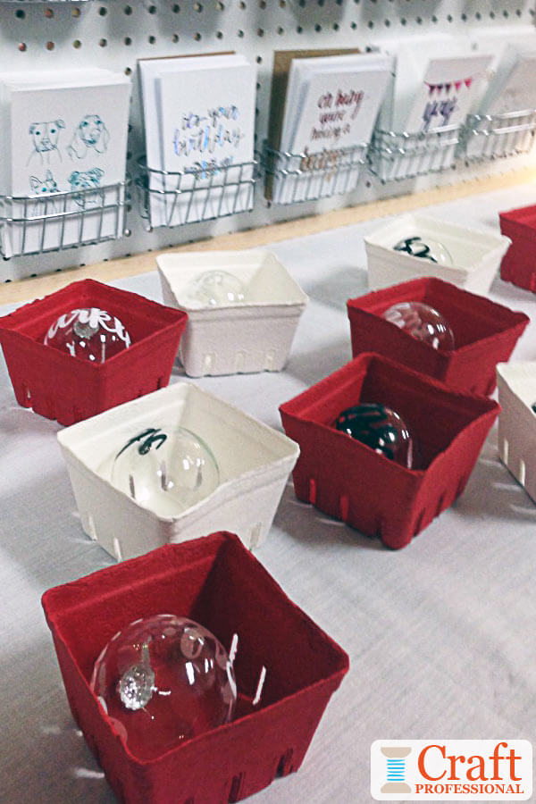 Handmade glass Christmas ornaments displayed in berry boxes painted red and white Handmade glass Christmas ornaments displayed in berry boxes painted red and white