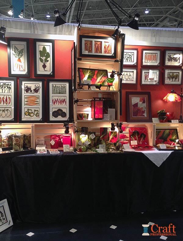 Framed prints displayed on tables covered with black fabric Framed prints displayed on tables covered with black fabric