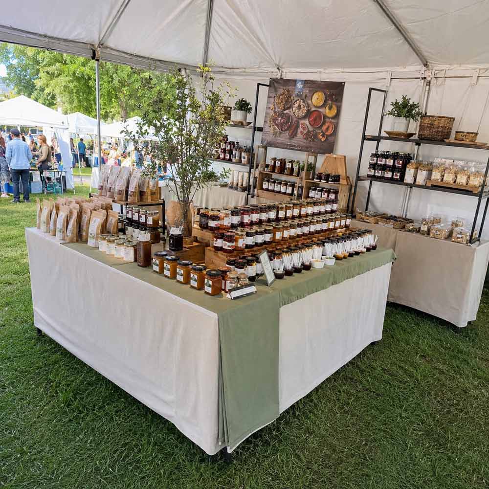 Handmade food displayed in an outdoor craft show booth, interior island layout.