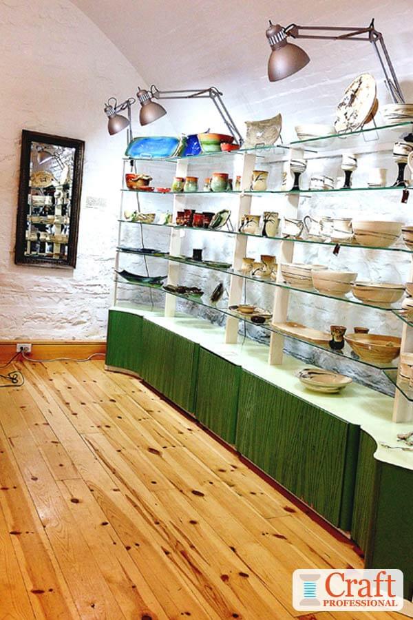 Pottery displayed on glass shelves.