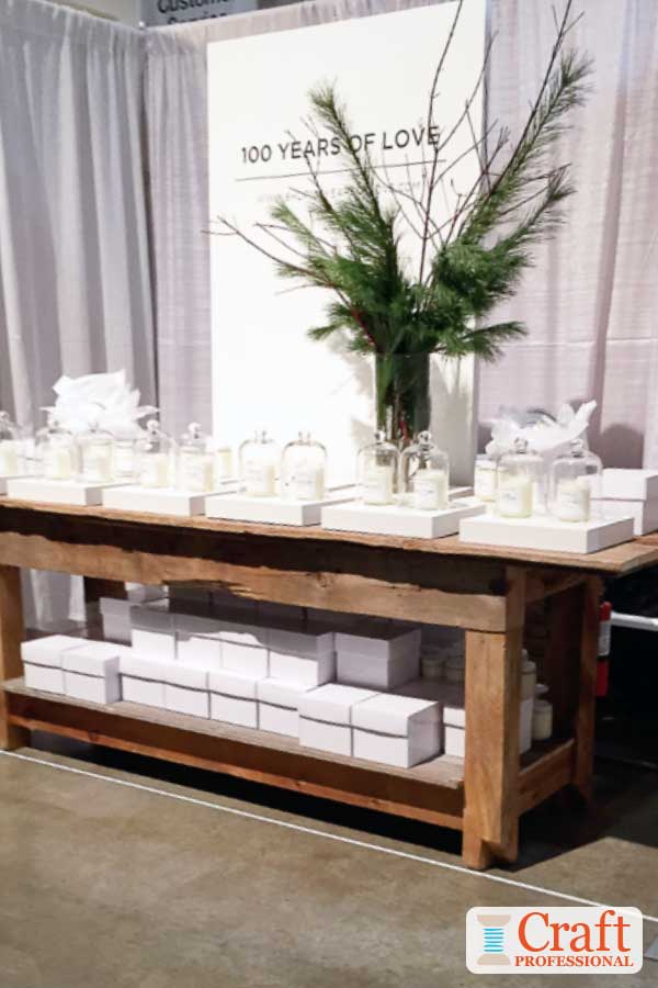 Handmade candles on a tabletop display at a holiday craft show. Handmade candles on a tabletop display at a holiday craft show.