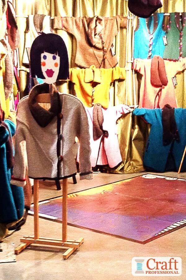 Handmade clothing displayed at a craft show.