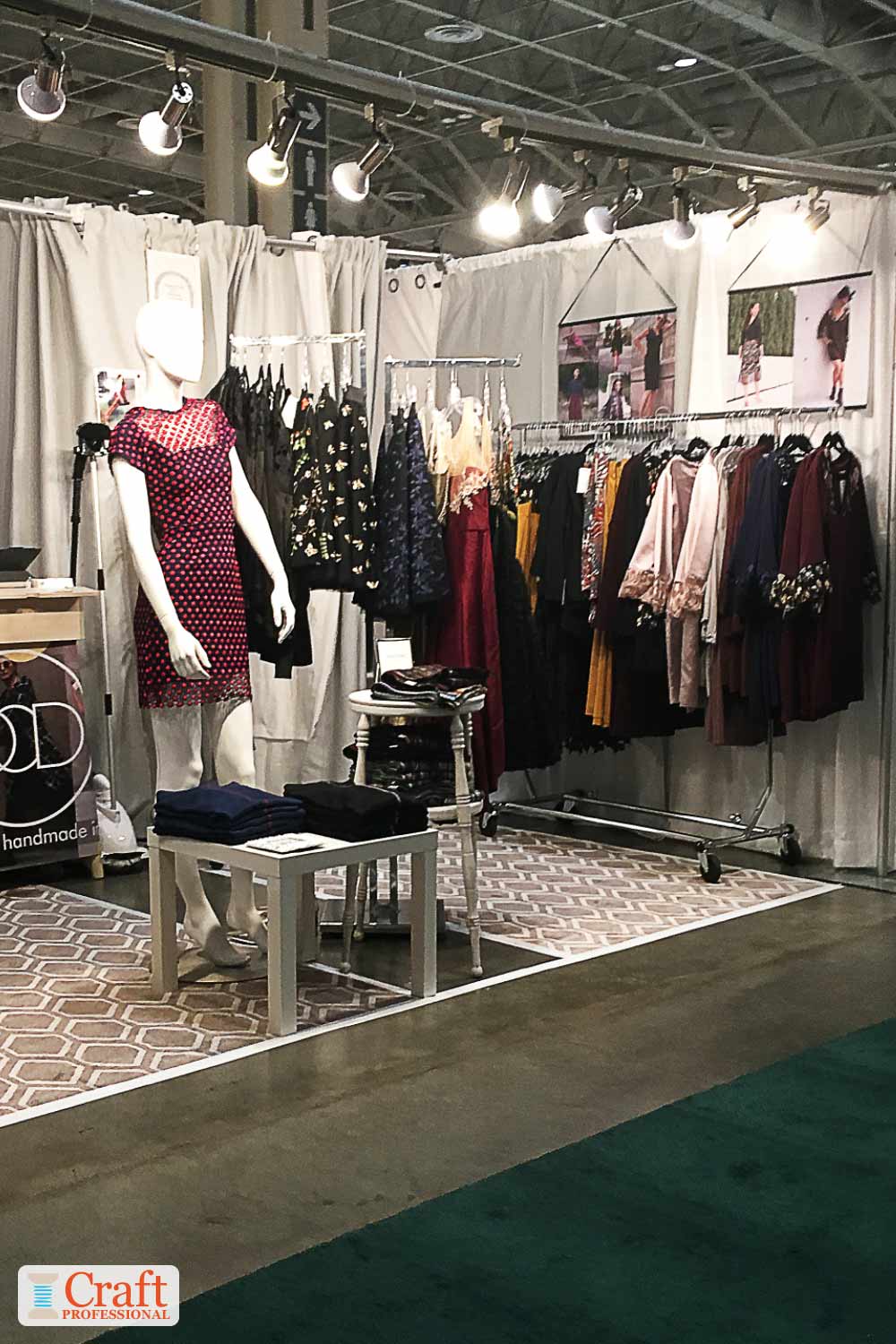 Handmade clothing in a craft show booth with overhead lighting Handmade clothing in a craft show booth with overhead lighting