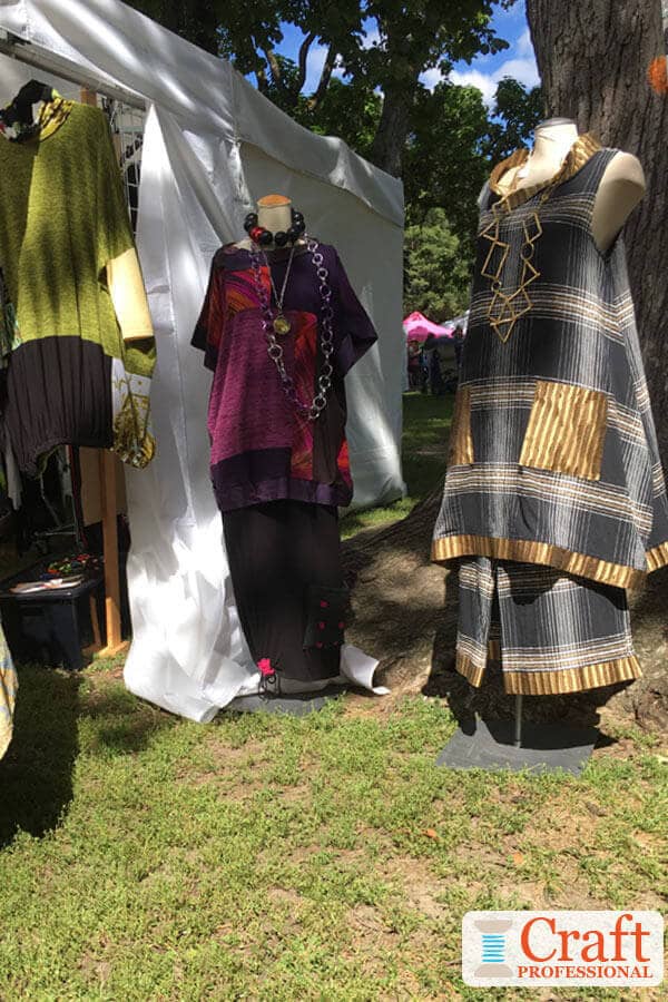 Clothing displayed on mannequins at an outdoor craft show. Clothing displayed on mannequins at an outdoor craft show.