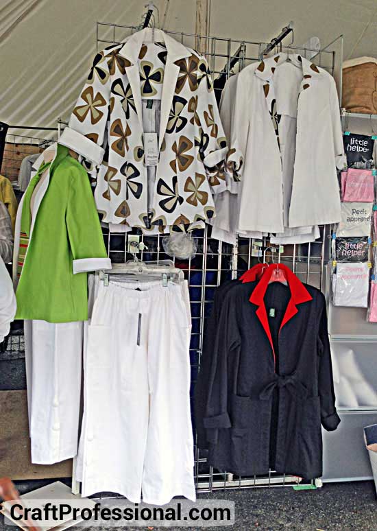 Handmade clothing displayed on grid wall panels Handmade clothing displayed on grid wall panels