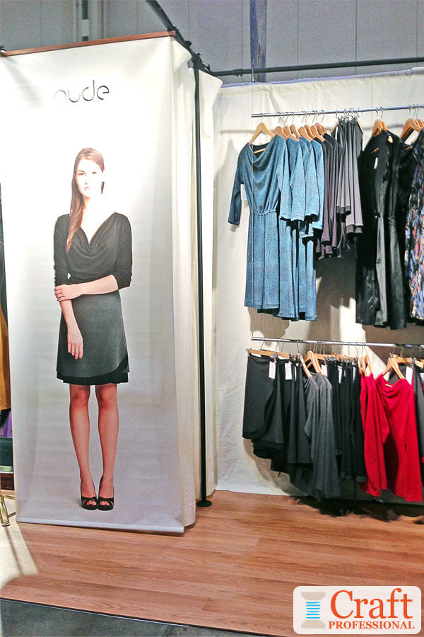 Life-size sign in a clothing display at a craft show Life-size sign in a clothing display at a craft show