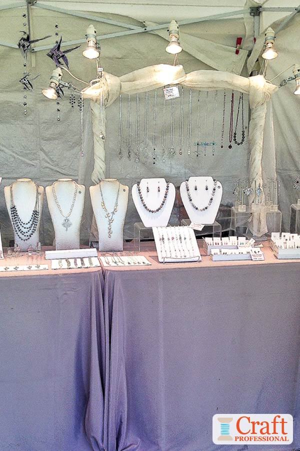 Handmade jewelry on a tabletop display with plenty of overhead lighting.
