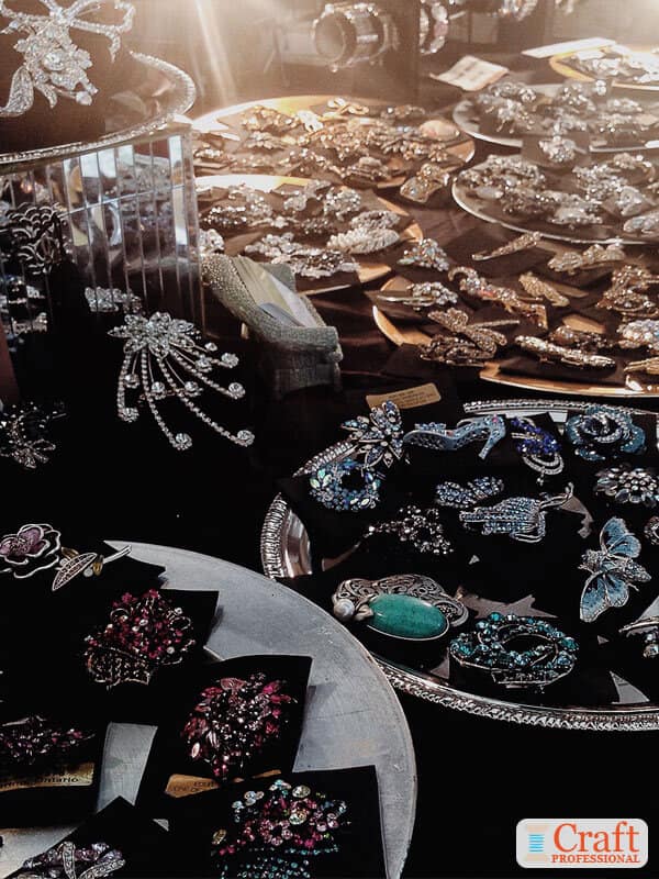 Handmade jewelry displayed on silver trays. Handmade jewelry displayed on silver trays.