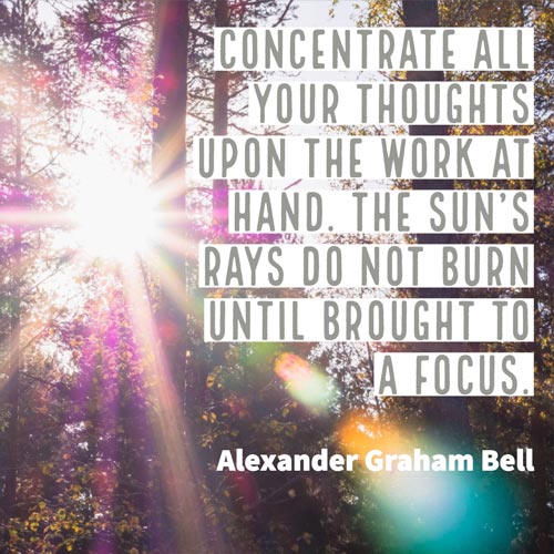 Sun's rays shining through trees. Text - Concentrate all your thoughts upon the work at hand. The sun's rays do not burn until brought into bright focus. Bell