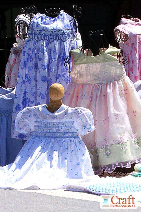 Children's dresses on display at an outdoor market. Children's dresses on display at an outdoor market.