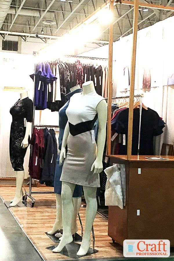 Mannequins display handmade dresses at a craft  show.