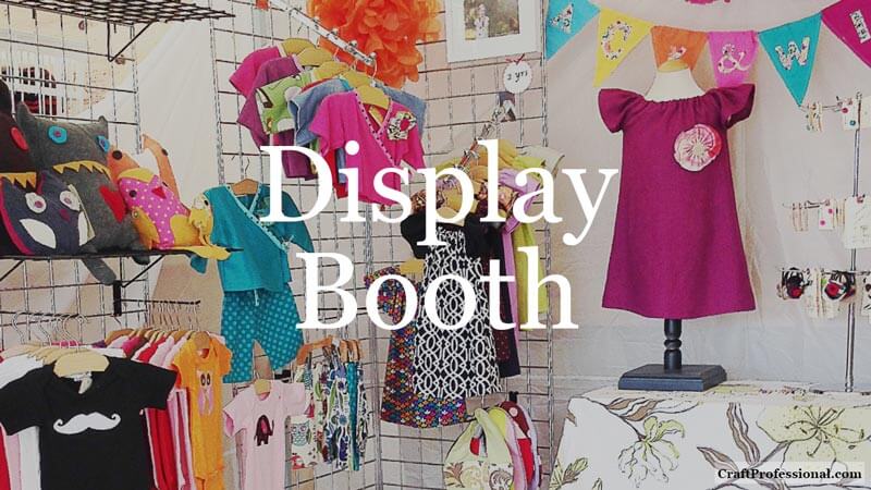 Check out these reader favorite craft business tips, including over original 1000 craft booth photos. Colorful children's clothing on display at a craft show. Text overlay - Display Booth
