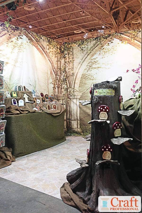 Garden decor display at a craft show. Beautiful, painted backdrop depicting whimsical outdoor scene. Garden decor display at a craft show. Beautiful, painted backdrop depicting whimsical outdoor scene.