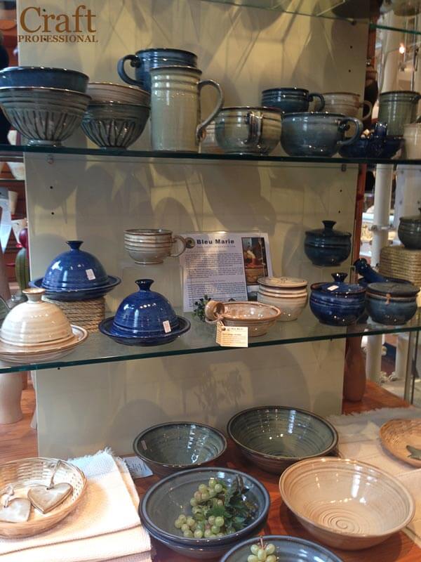 Handmade pottery on glass shelves Handmade pottery on glass shelves