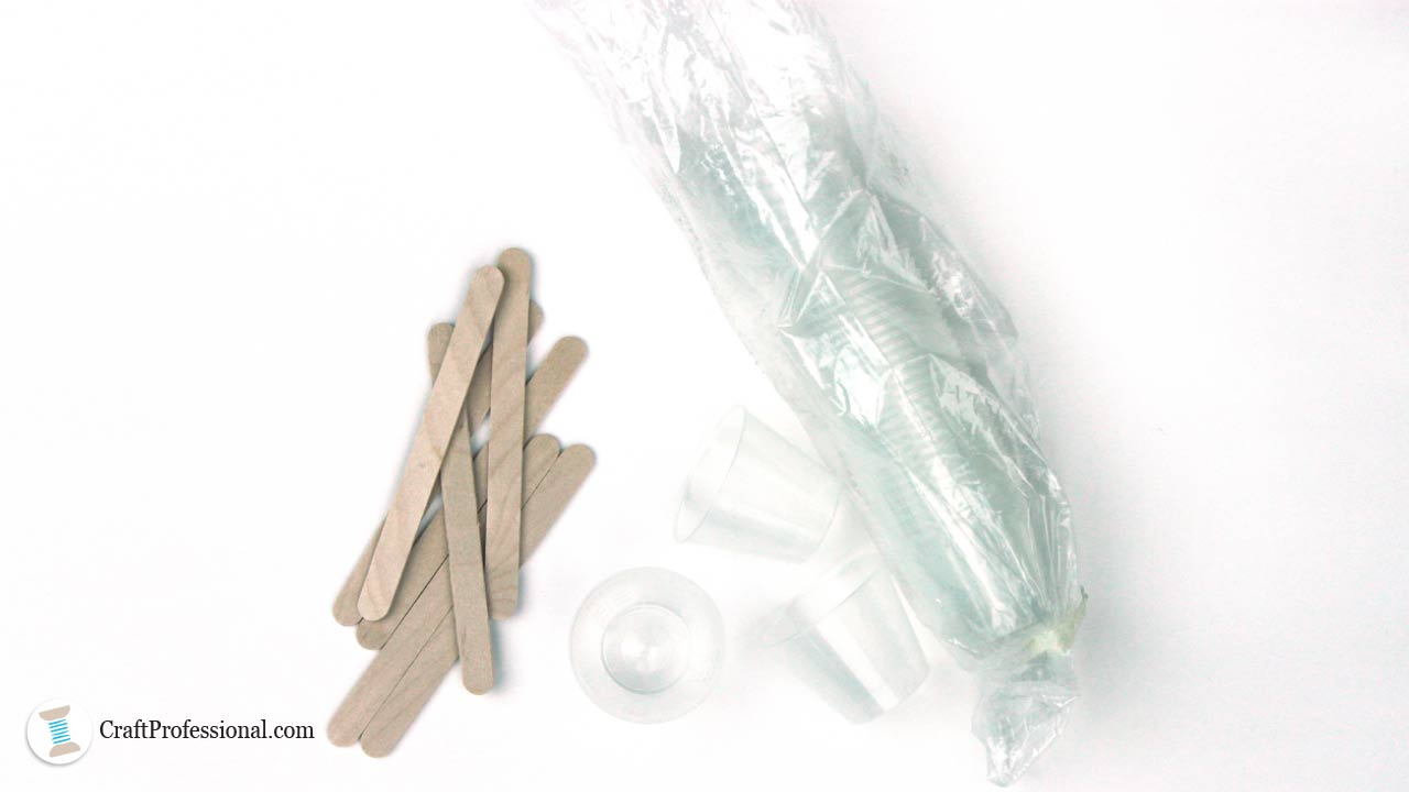 Graduated medicine cups and craft sticks for measuring and mixing resin