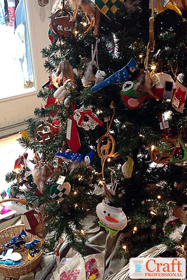 Christmas tree decorated with handmade ornaments at a craft show. Christmas tree decorated with handmade ornaments at a craft show.