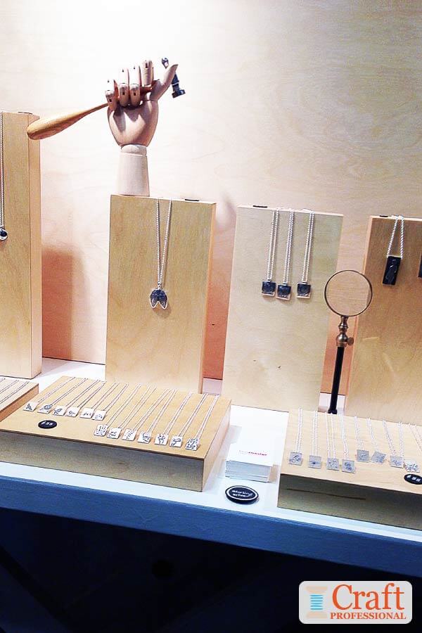 Wood blocks and necklace stands provide a simple, effective way to display handmade jewelry. Handmade silver necklaces displayed on simple, wood blocks and stands.