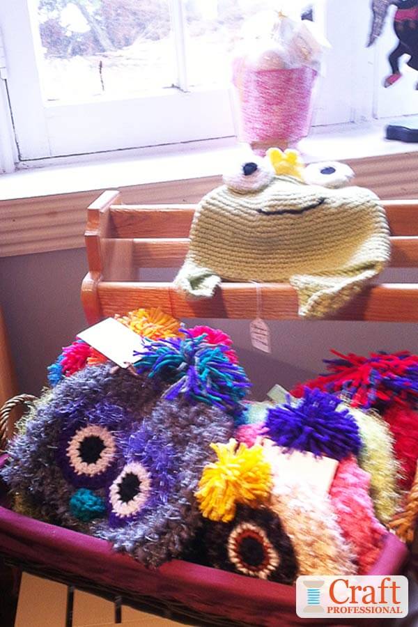 Handmade hats on display in a basket at a craft show. Handmade hats on display in a basket at a craft show.
