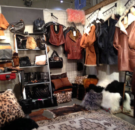 Handmade leather clothing and accessories displayed at a craft show Handmade leather clothing and accessories displayed at a craft show