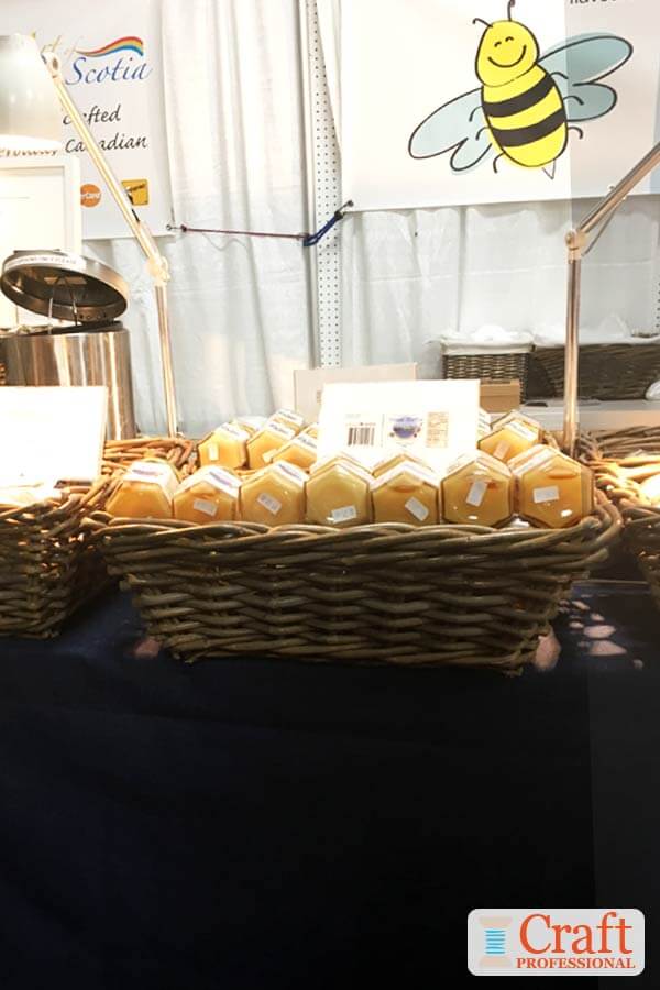 Honey jars displayed at a craft fair. Honey jars displayed at a craft fair.