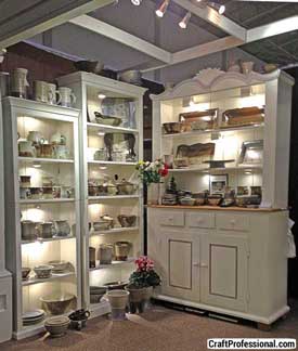 Handmade tableware displayed on large shelves. Handmade tableware displayed on large shelves.