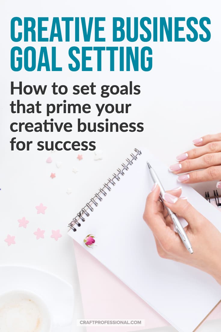Woman writing business goals in a notebook. Text - Creative business goal setting - How to set goals that prime your creative business for success. Woman writing business goals in a notebook. Text - Creative business goal setting - How to set goals that prime your creative business for success.