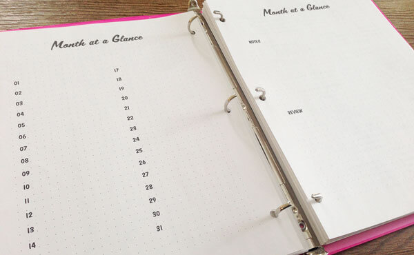 Month at a glance pages in a planning binder Month at a glance pages in a planning binder