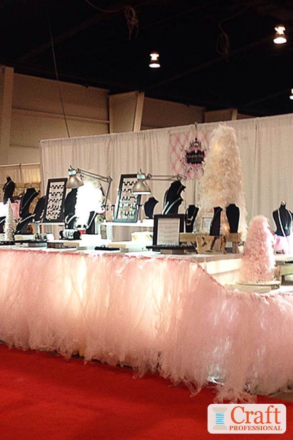 Handmade jewelry in a well lit table top display.