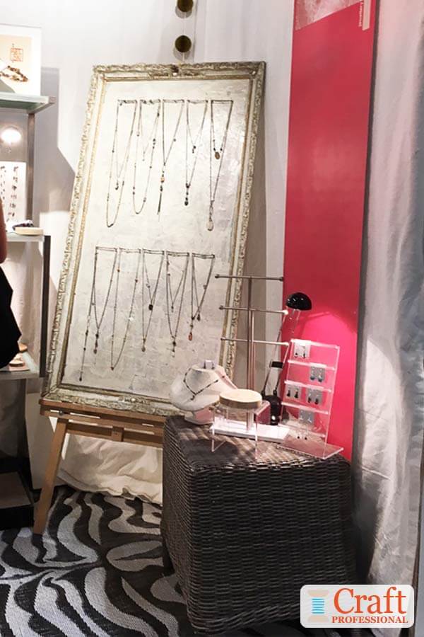 Handmade necklaces displayed on an extra large frame.