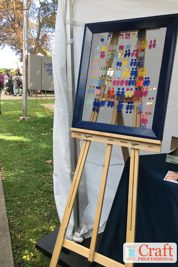 Earrings displayed on a frame set on an art easel. Earrings displayed on a frame set on an art easel.