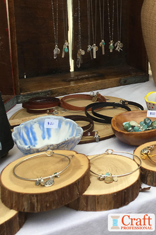 Handmade bracelets displayed on wood rounds. Handmade bracelets displayed on wood rounds.