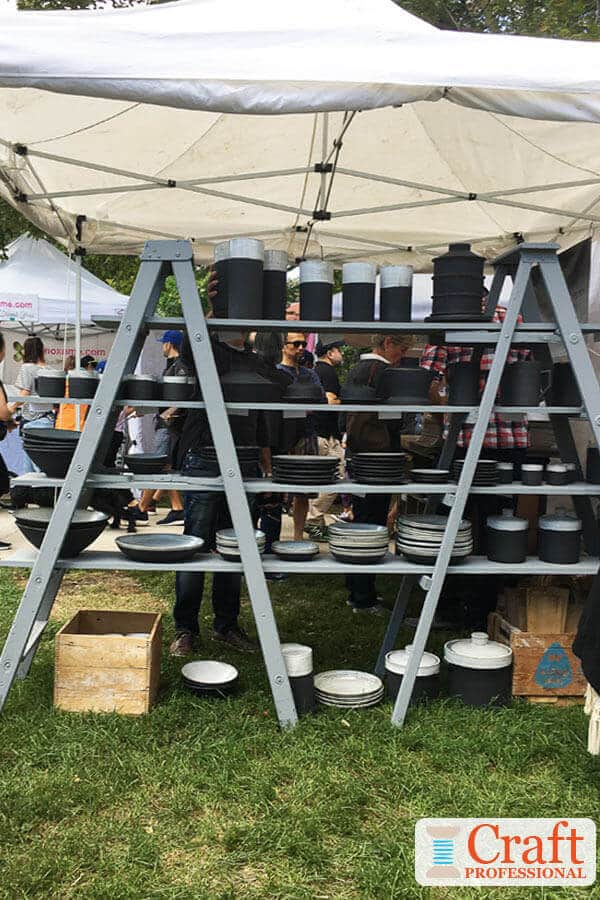 Pottery on display at an outdoor craft show.