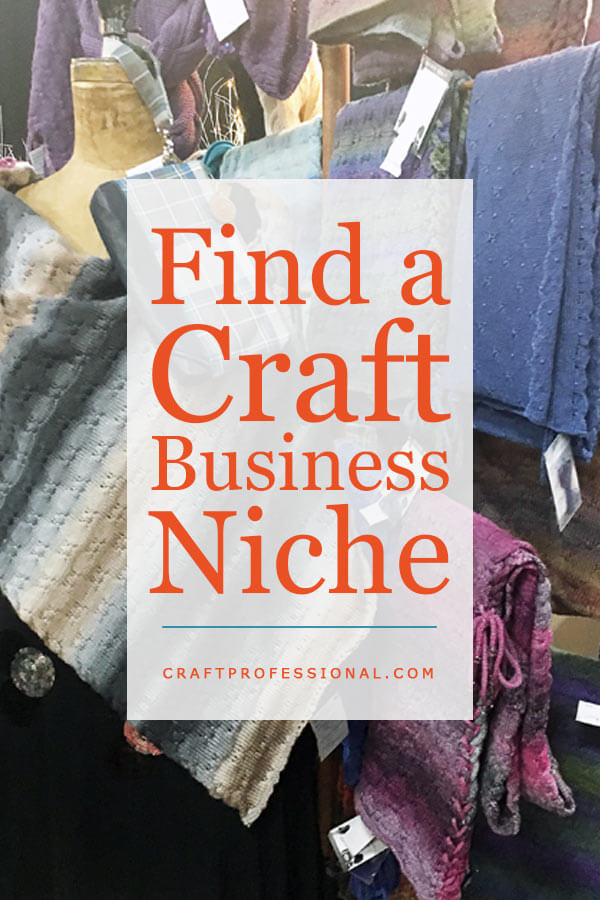 Handmade scarves on display in a craft booth with text overlay - Find a Craft Business Niche