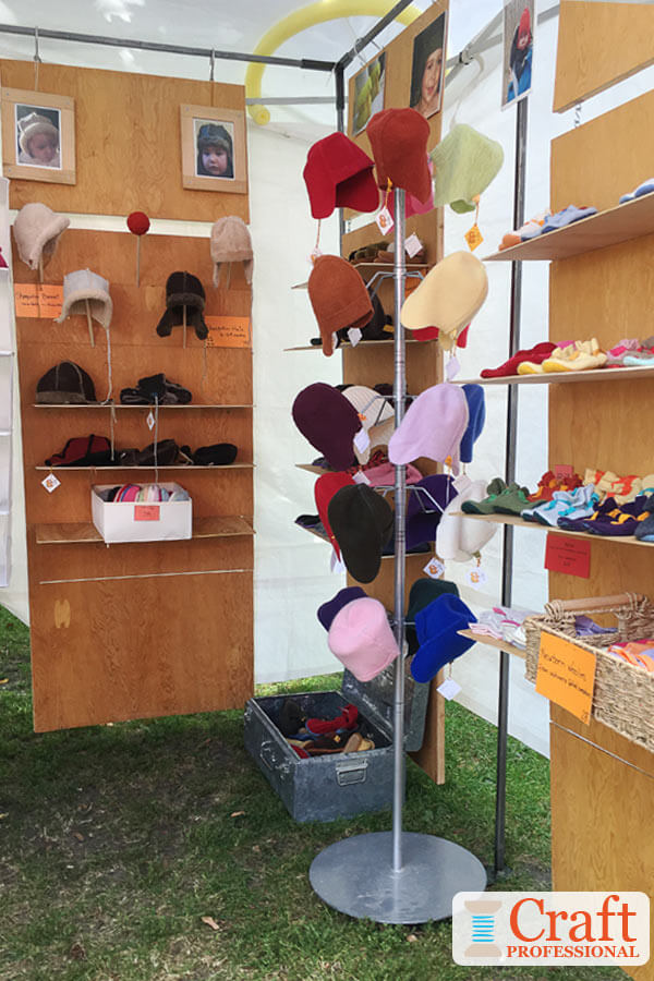 Outdoor craft show booth. A pool noodle is placed between the canopy and frame of the craft tent to reduce slack and prevent water from pooling on the tent if it rains.