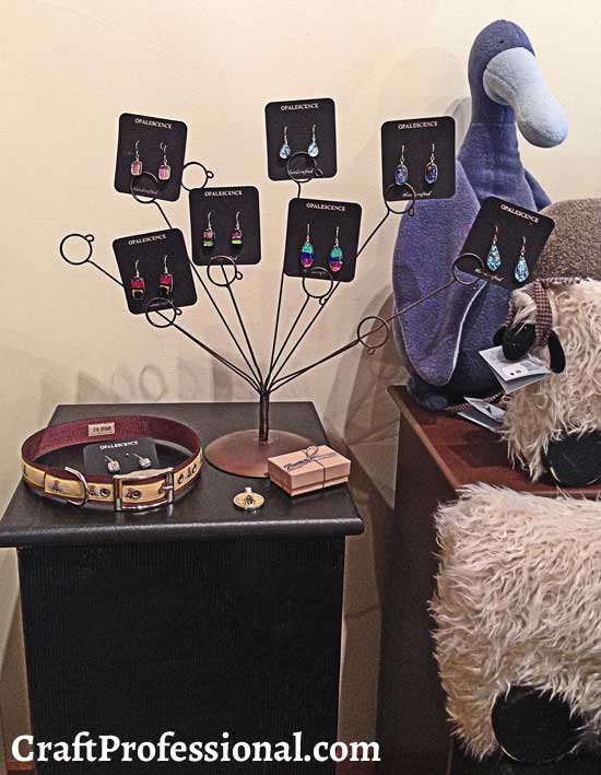 Photo stand used to display handmade earrings in a retail shop.