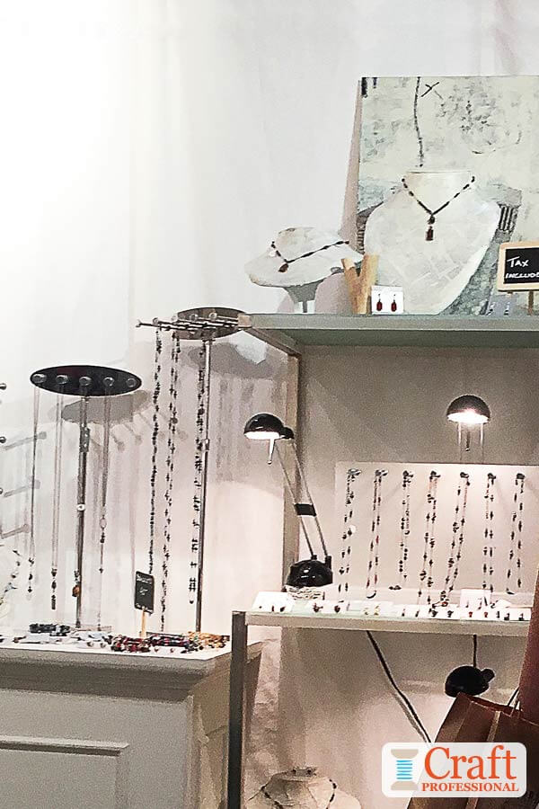 Portable jewelry booth display with spotlights.