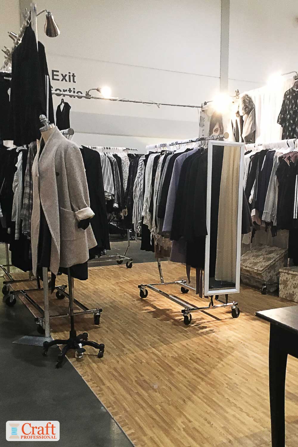 Clothing booth display at a craft show with overhead lighting Clothing booth display at a craft show with overhead lighting