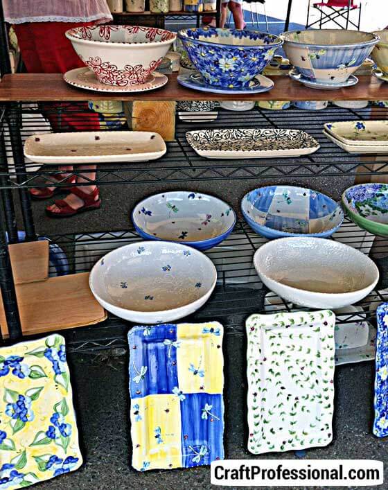 Pottery displayed on wire shelves at a craft show Pottery displayed on wire shelves at a craft show