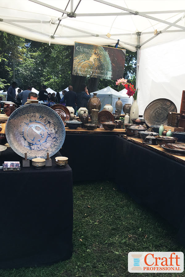 Handmade pottery on display at a craft show Handmade pottery on display at a craft show