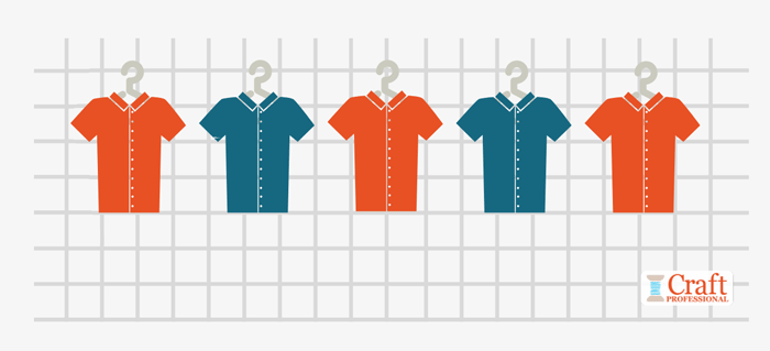 Five shirts hanging on a grid wall show the visual merchandising technique of repetition with alternation