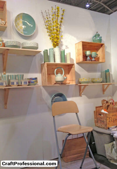 Handmade pottery displayed in a simple, uncluttered craft booth.