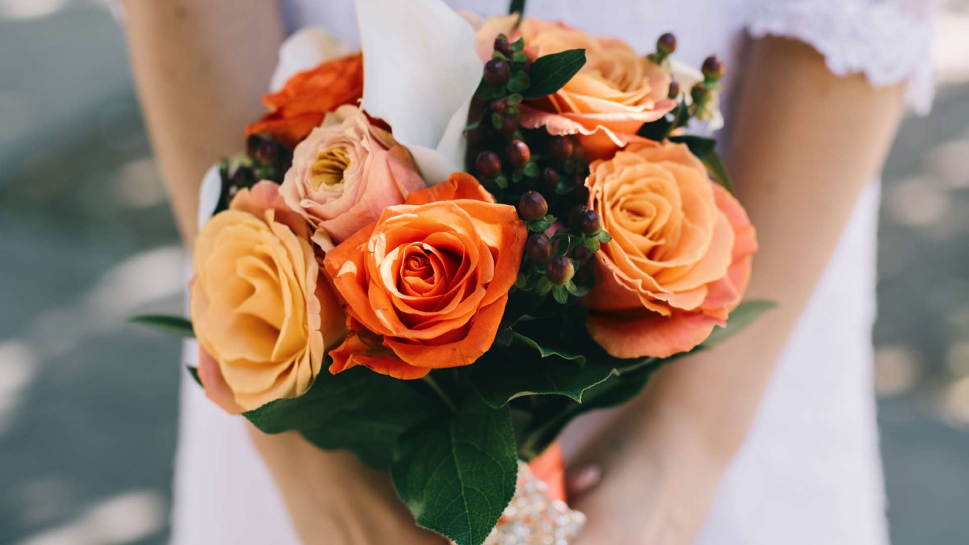 Burnt orange roses in wedding bouquet