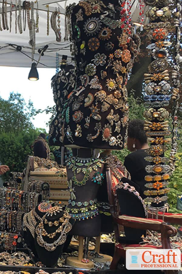 Unique handmade jewelry display on a black background.