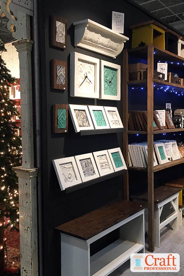 Bold color can be very effective in craft show displays. Click through for 6 more craft booth photos showing how to use tested visual merchandising techniques in your own 10x10 display. Handmade clocks displayed against a black backdrop at a craft show.