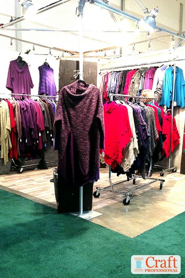 Handmade clothing displayed in  10x10 craft booth. Lights are secured to a metal frame around the outside perimeter of the booth at approximately one light per foot.