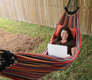 Working on a laptop in a hammock in the back yard. Working on a laptop in a hammock in the back yard.